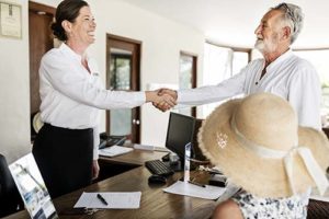 two people shaking hands during a luxury senior advisory services meeting